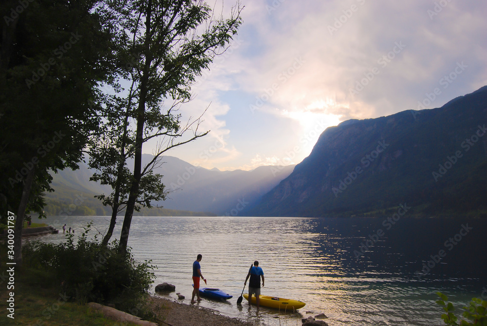 Two men preparing for kayaking in Lake Bohinj in Slovenia Two men preparing for kayaking in Lake Bohinj in Slovenia
