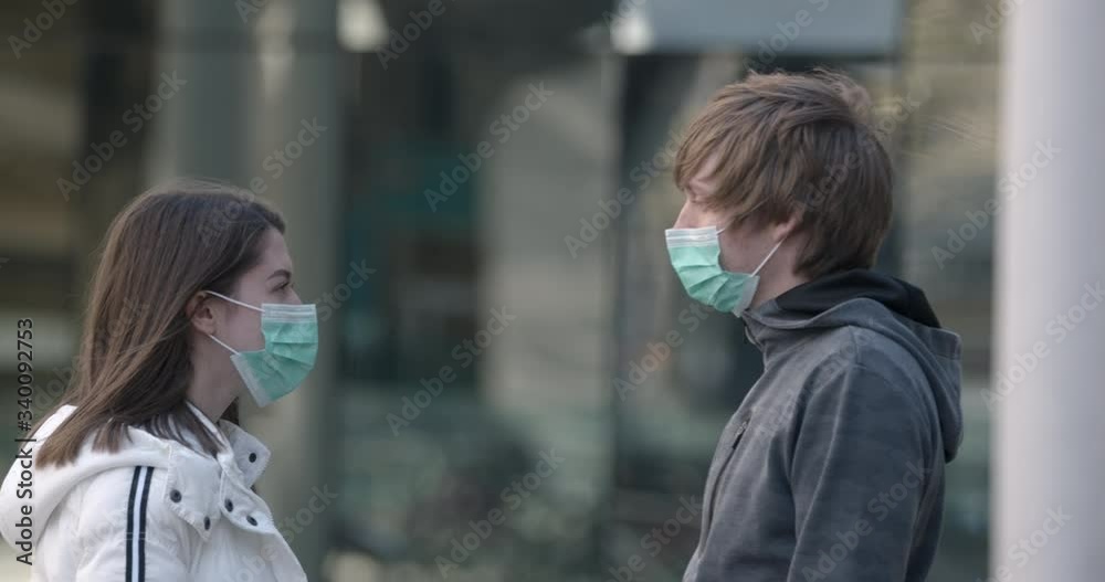 Man checking the body temperature of his friend/partner in time of coronavirus, looking for symptoms Man checking the body temperature of his friend/partner in time of coronavirus, looking for symptoms