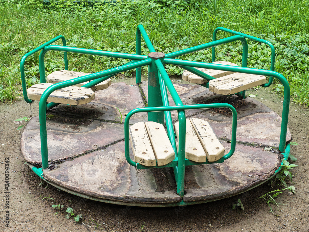 Round green swing in the playground on street Round green swing in the playground on street