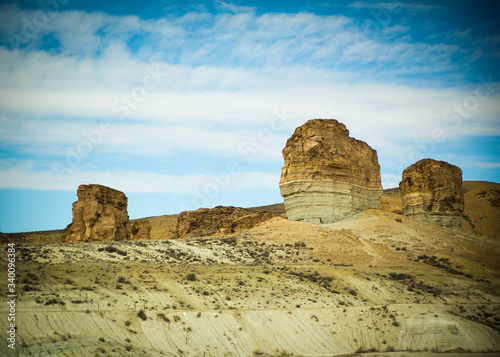Cliffs Rising Out of the Southwestern Desert with Blue Sky and White Clouds