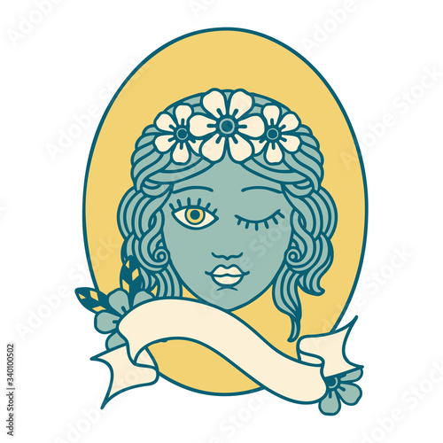 tattoo with banner of a maiden with crown of flowers winking
