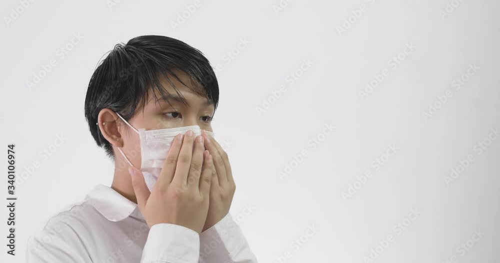 Asian woman putting on surgical face mask for protection against coronavirus.
Asian woman putting on surgical face mask for protection against coronavirus.