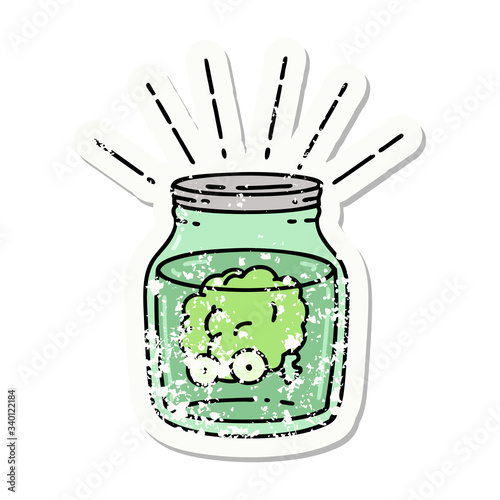 grunge sticker of tattoo style brain in jar