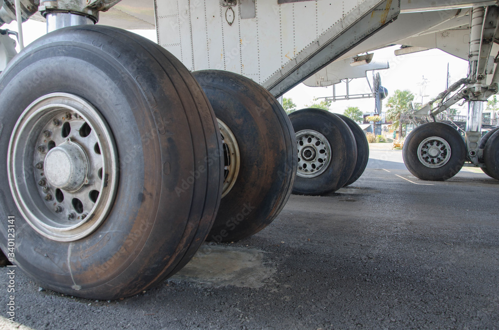 Old big black back wheels of airplane on the floor Old big black back wheels of airplane on the floor