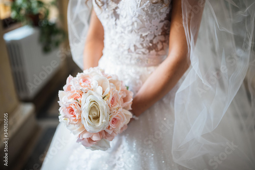 Beautiful bride with bridal bouquet in hand