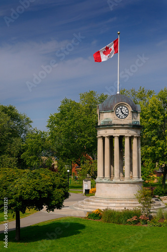 Old City Hall Clock Tower in Victoria Park Kitchener with Canadian flag photo