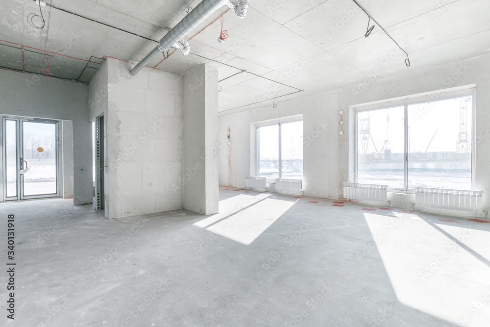 empty pure commercial office building undecorated in gray colors.open space office empty pure commercial office building undecorated in gray colors.open space office