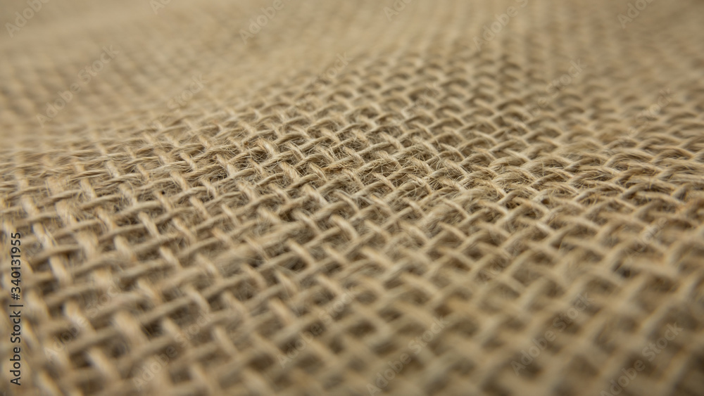 Rough burlap hessian sack cloth. Close up of fabric surface with shallow depth of field. Rough burlap hessian sack cloth. Close up of fabric surface with shallow depth of field.
