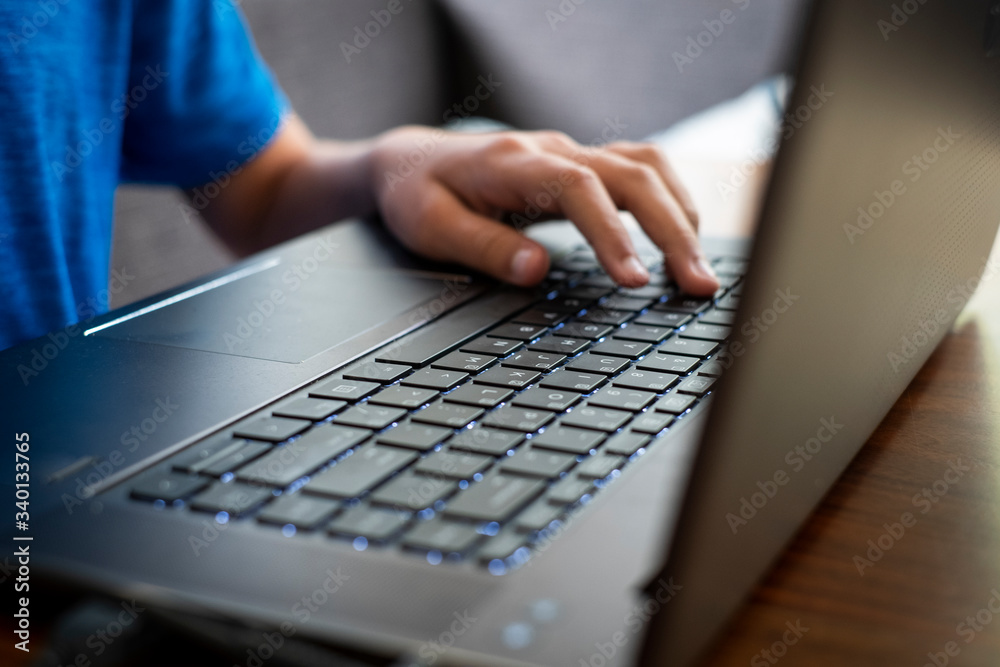 Student does his school assignments on a laptop at home during the Covid-19 shelter in place order. Student does his school assignments on a laptop at home during the Covid-19 shelter in place order.
