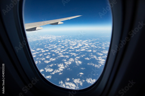 cloudscape against blue sky through air plane window