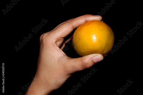 hand holding fresh sliced orange fruit