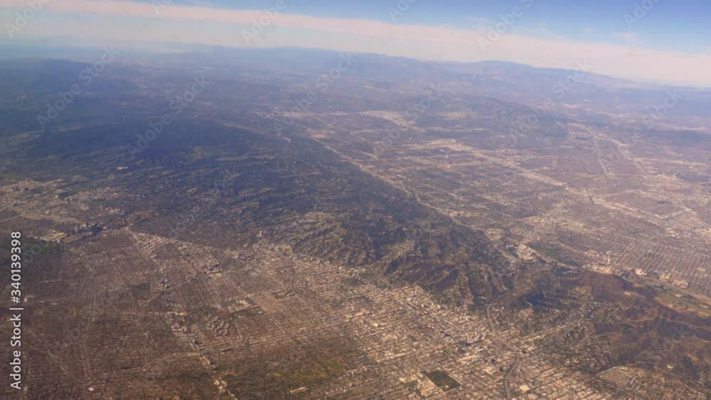 Aerial view of Los Angeles Suburbs and mountains California in America USA out from flying airplane window shot in 4k Aerial view of Los Angeles Suburbs and mountains California in America USA out from flying airplane window shot in 4k