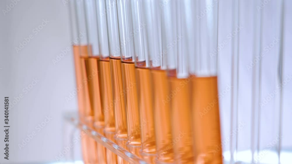 The orange fluids inside the long glass tubes The orange fluids inside the long glass tubes