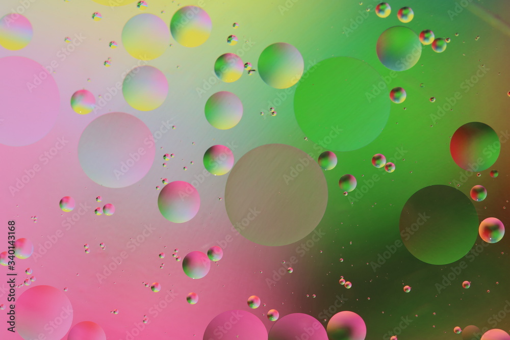 macro of oil mixed with water on colorful red, pink, green and orange background, colourful circles, copy space, vertical macro of oil mixed with water on colorful red, pink, green and orange background, colourful circles, copy space, vertical