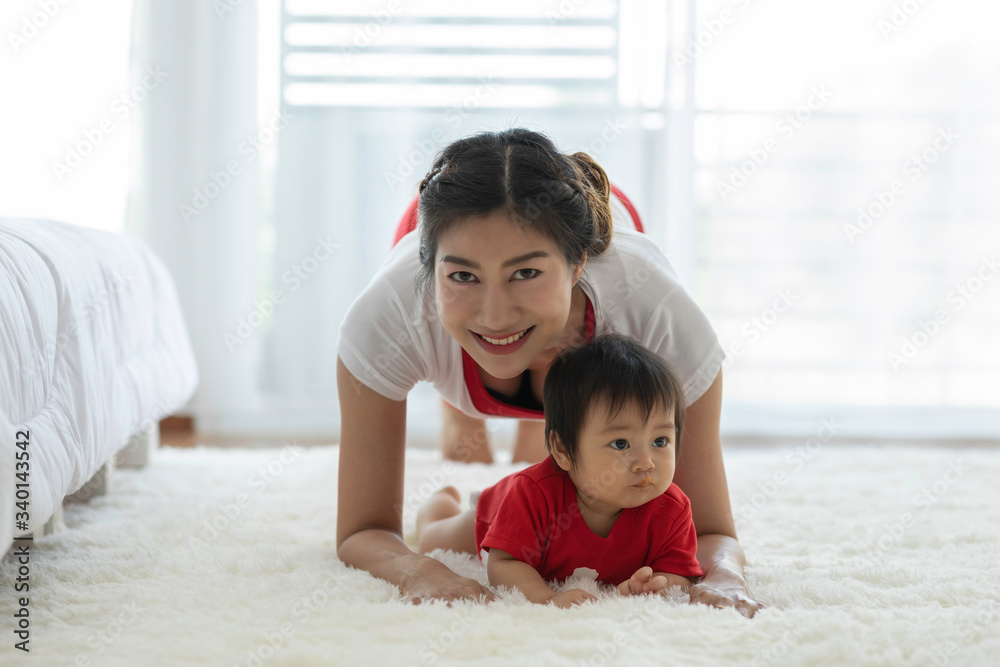Attractive Mother Asian woman practice yoga with baby to meditation in bedroom after wake up in the morning Feeling so comfortable and relax,Yoga with Baby for Healthcare Concept Attractive Mother Asian woman practice yoga with baby to meditation in bedroom after wake up in the morning Feeling so comfortable and relax,Yoga with Baby for Healthcare Concept