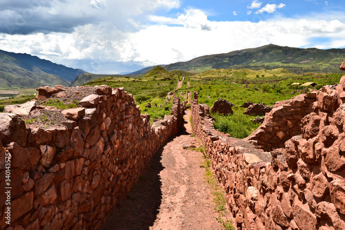 Ancient walls of ruins belonging to pre Hispanic culture of Peru and the Andes mountain located in Peru in the Inca Sacred valley near the city of Cuzco (or Urubamba valley) made of red and grey stone