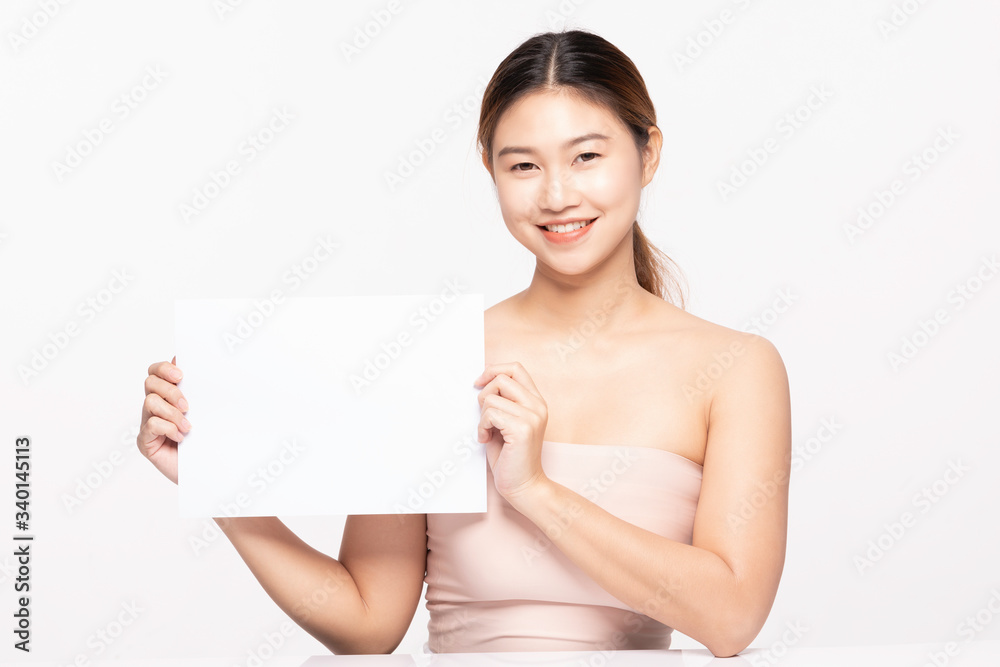 Attractive Asian young woman smile with holding blank paper for display text or cosmetics product so happy and cheerful with healthy Clean and Fresh skin,isolated on white,Beauty Cosmetology Concept Attractive Asian young woman smile with holding blank paper for display text or cosmetics product so happy and cheerful with healthy Clean and Fresh skin,isolated on white,Beauty Cosmetology Concept