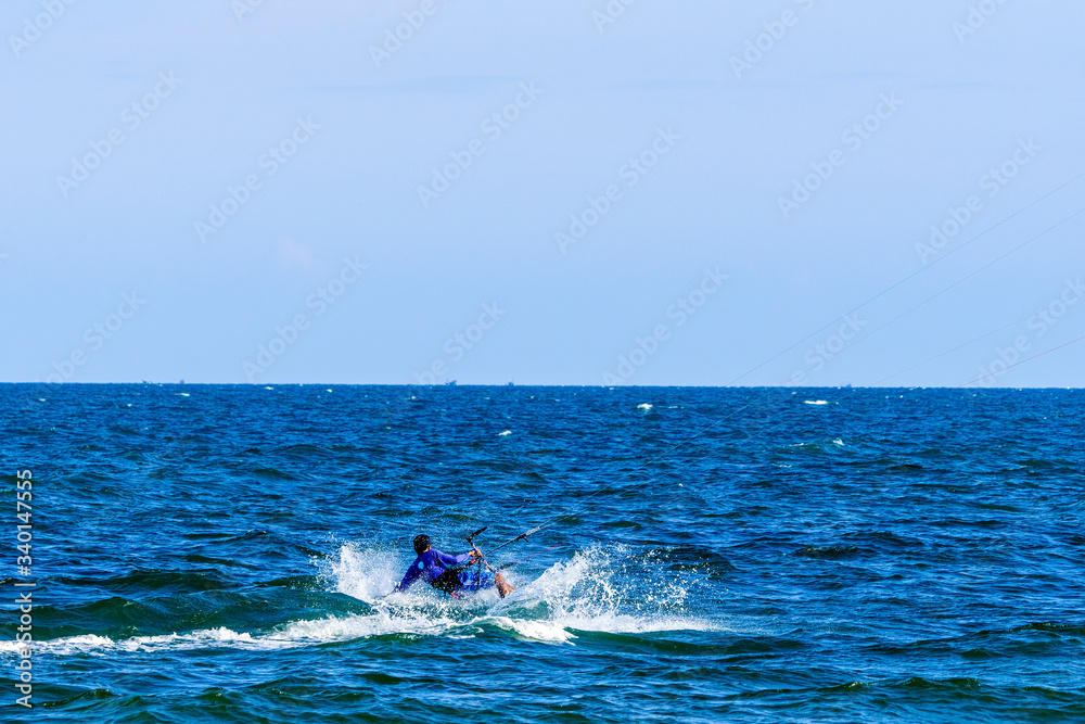 Obraz premium Aerial view of Kitesurfing on the waves of the sea in Mui Ne beach, Phan Thiet, Binh Thuan, Vietnam. Kitesurfing, Kiteboarding action photos