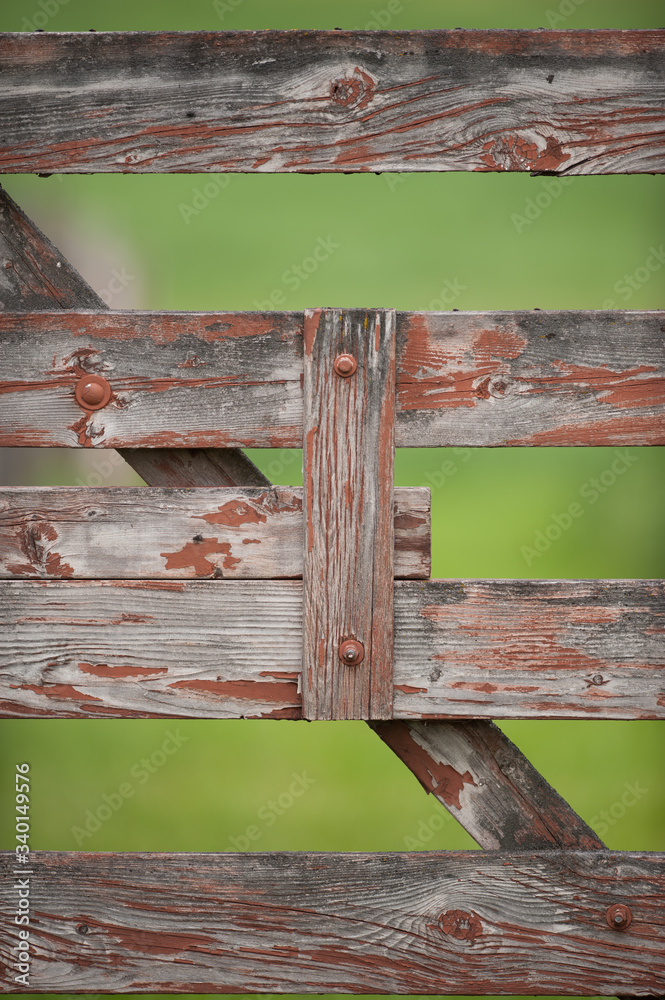 Red Wooden gate with  Paint Peeling and Weathered Wood horizontal and diagonal lines of wood gate