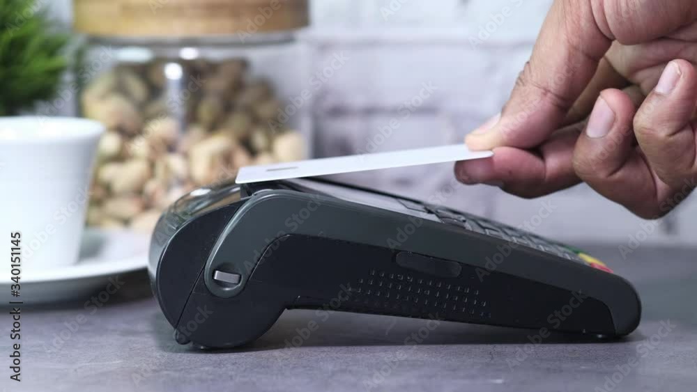 Payment terminal charging from a credit card , close up Payment terminal charging from a credit card , close up