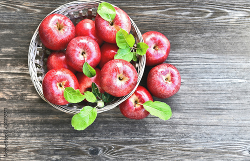a lot of Red apples or Gala apples with fresh leaf  on wooden background. photo