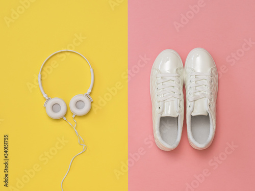 White headphones on a yellow background and white sneakers on a pink background.