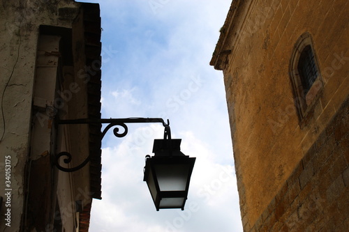 Street lamp on a wall in a narrow street