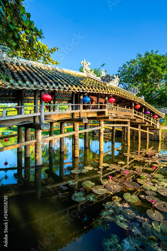 Wonderful view of the "Cau Ngoi Thanh Toan " or Thanh Toan tile bridge near Imperial City with the Purple Forbidden City within the Citadel in Hue, Vietnam. 
