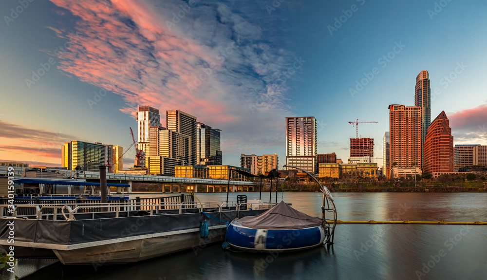 Fototapeta premium Panorama with downtown view across Lady Bird Lake or Town Lake on Colorado River at sunset golden hour, Austin Texas USA