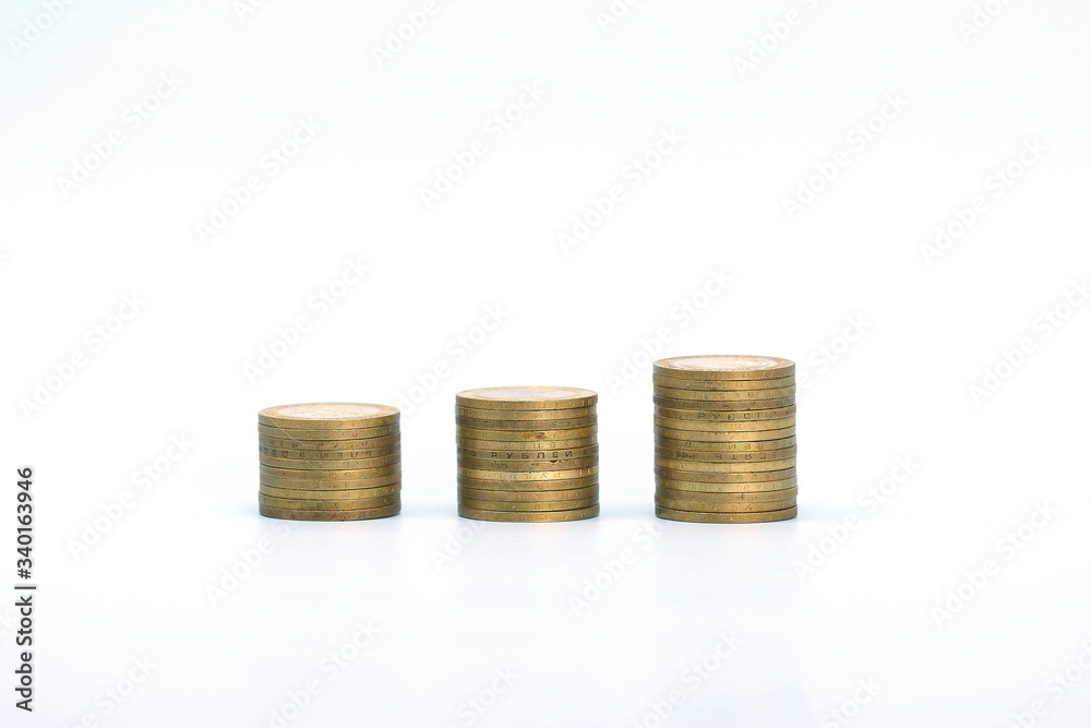 Piles of golden metallic coins. Columns of coins of different heights. The concept of business, economy, finance, investment and prices. Place for text and background for design. Piles of golden metallic coins. Columns of coins of different heights. The concept of business, economy, finance, investment and prices. Place for text and background for design.