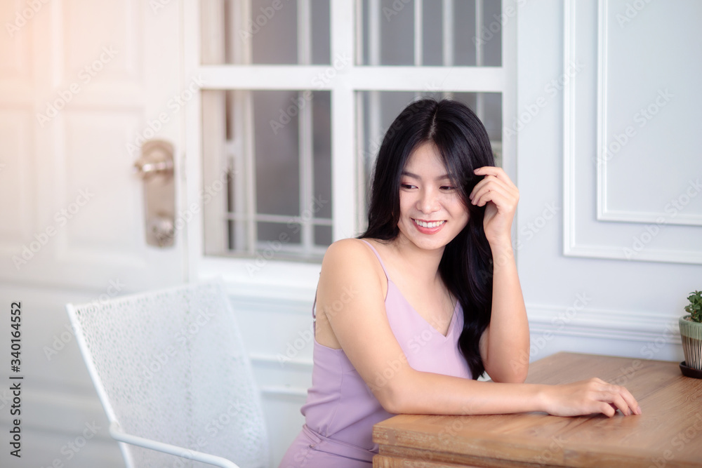 Beautiful Asian woman wear dress pants pink. Sitting on chair and white background. Beautiful Asian woman wear dress pants pink. Sitting on chair and white background.