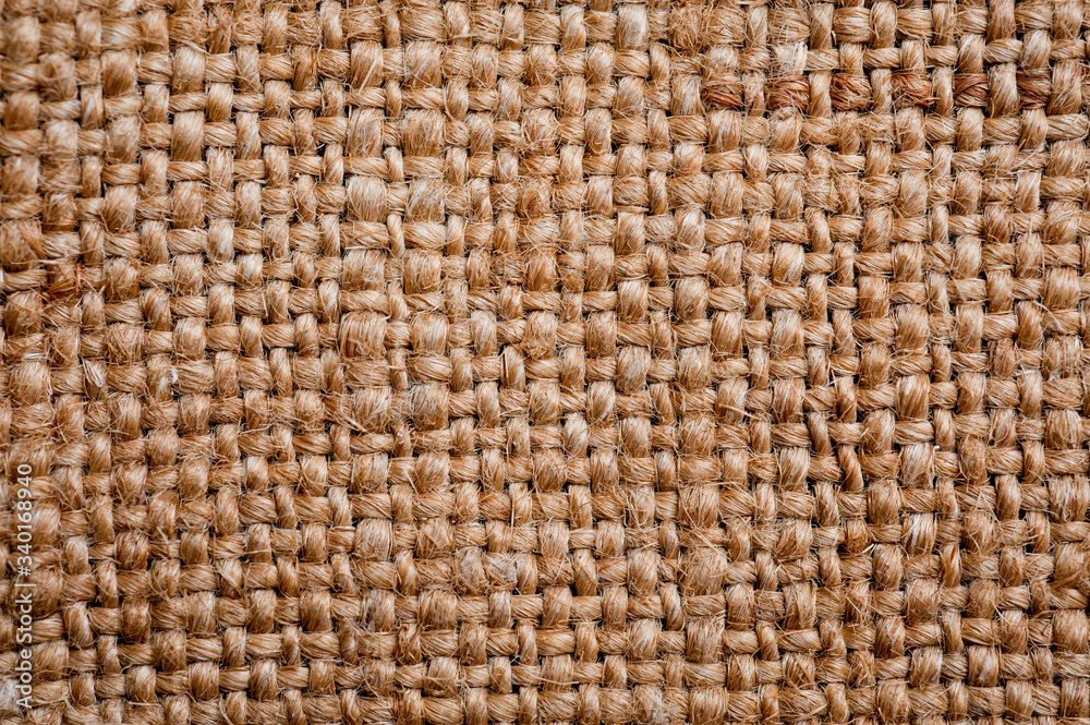 A canvas napkin lying on a wooden surface. Background for fall and natural objects. A canvas napkin lying on a wooden surface. Background for fall and natural objects.