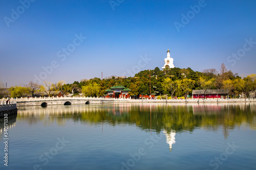 The white tower in Beihai Park, Beijing, China. Stone bridge and lake water in Beihai Park.