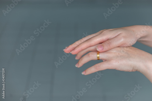 Woman washing hands rubbing with alcohol, which is key in efforts to halt the spread of Corona virus (COVID-19) © JokimiyaPhoto