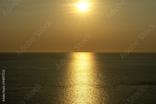 Golden sky and the setting sun scenery at the famous view point in Phuket Island, Thailand.