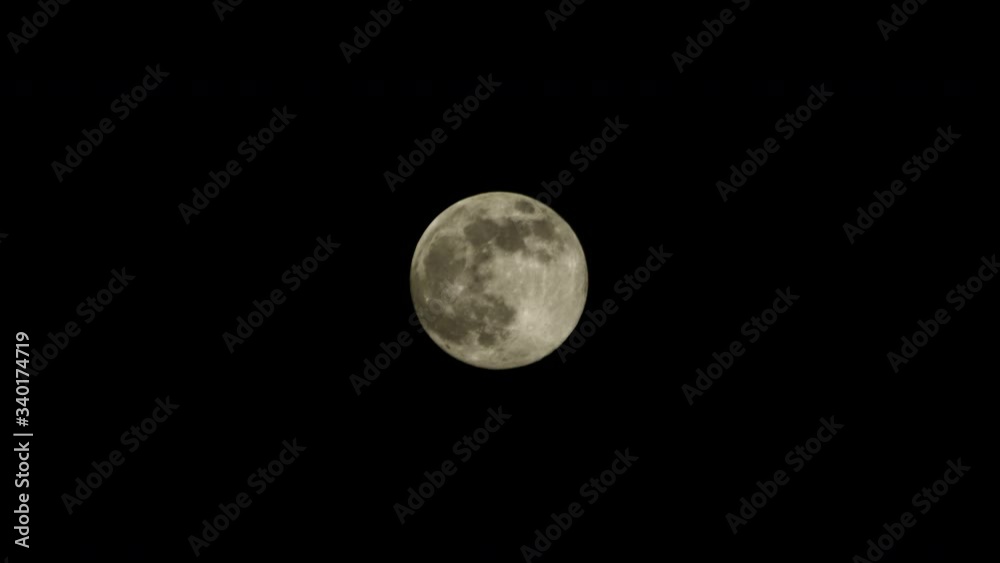 A full moon against a pitch black clear night sky. A full moon against a pitch black clear night sky.