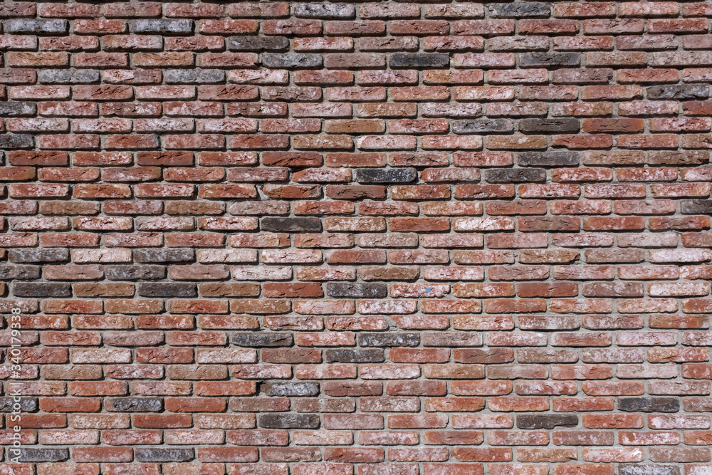 Fototapeta premium Weathered texture of stained old dark brown and red brick wall background, grungy rusty blocks of stone-work technology, colorful horizontal architecture