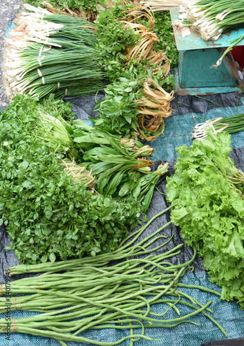 Various vegetable stacks are sold at the market in Laos.