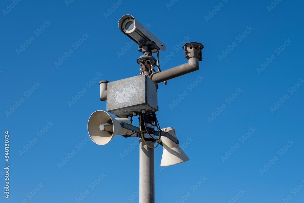 Security camera's outside with blue sky backdrop Security camera's outside with blue sky backdrop