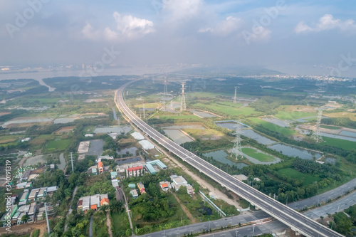 Top view aerial of Long Thanh - Ben Luc expressway. View from  Hiep Phuoc industrial zone. Ho Chi Minh city center, Vietnam with development buildings, transportation, energy power infrastructure © Hien Phung