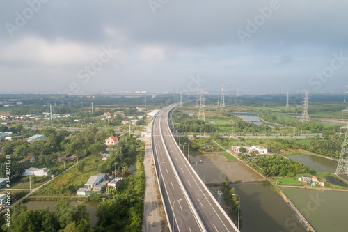 Top view aerial of Long Thanh - Ben Luc expressway. View from Hiep Phuoc industrial zone. Ho Chi Minh city center, Vietnam with development buildings, transportation, energy power infrastructure