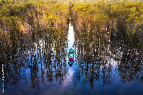 Aerial view, Vietnam landscape at Mekong Delta, canal through melaleuca forest, nice scenery with entrance gate to heaven make wonderful place for ecotourism photo