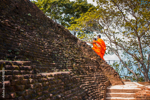 Buddhist monks climb a mountain