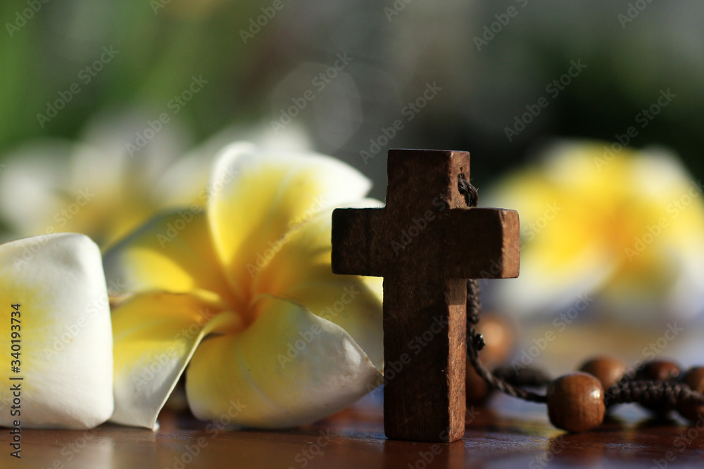 Wooden rosary with Jesus Christ holy cross crucifix and Bali frangipani  flowers decoration background. Christian catholic religion concept with  religious symbol. Easter or Month of Rosary concept. Stock Photo | Adobe  Stock