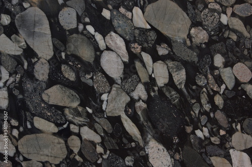 Natural granite with different pebbles in black and gray shades of color is called Nero Marinace photo