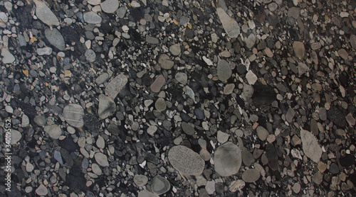 Natural granite with pebbles of black and gray shades of color frozen in it is called Nero Marinace