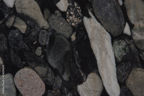 Granite with pebbles in black and gray shades called Nero Marinace photo