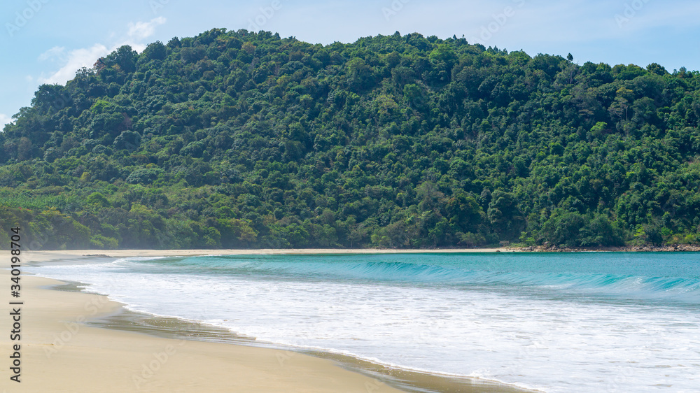 Turquoise sea water surrender by a mountain with many green trees. Empty Sin Htauk Beach in Myanmar. Turquoise sea water surrender by a mountain with many green trees. Empty Sin Htauk Beach in Myanmar.