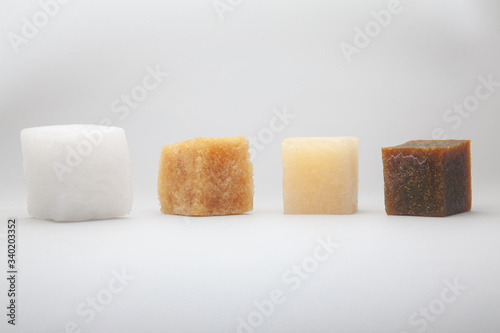 four multi-colored cubes synthetic rubber samples on a white background shot close up