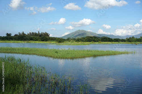 Scenic view of lake and mountains against sky, Hong Kong Wetland Park photo